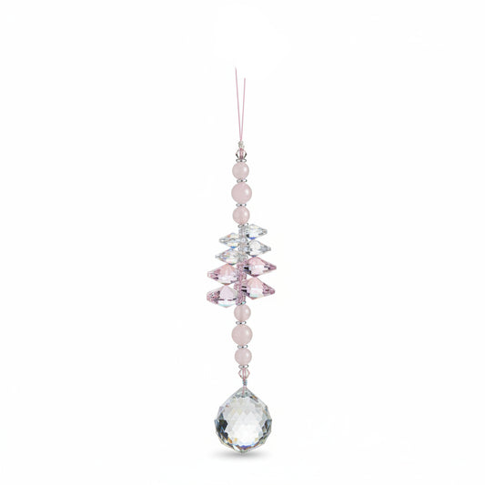 A beaded crystal wind chime ornament with white and iridescent beads, hanging on a wooden surface. The top tag reads 'Breathe.