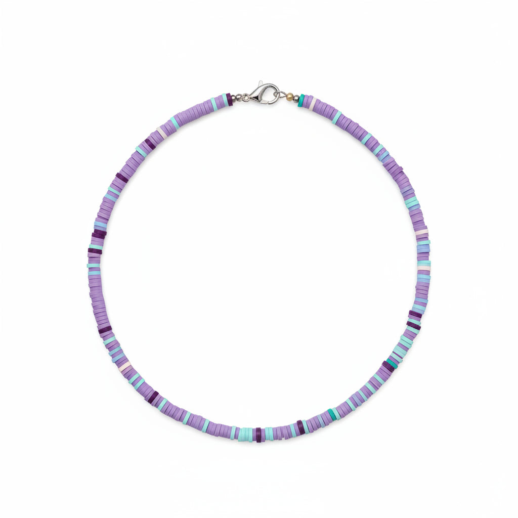 Person wearing a colorful beaded necklace with a blurred background