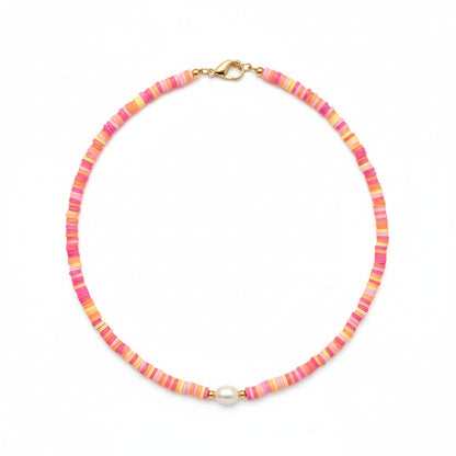Person wearing a colorful beaded necklace on a plain background