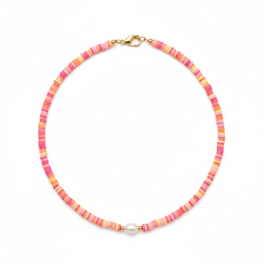 Person wearing a colorful beaded necklace on a plain background