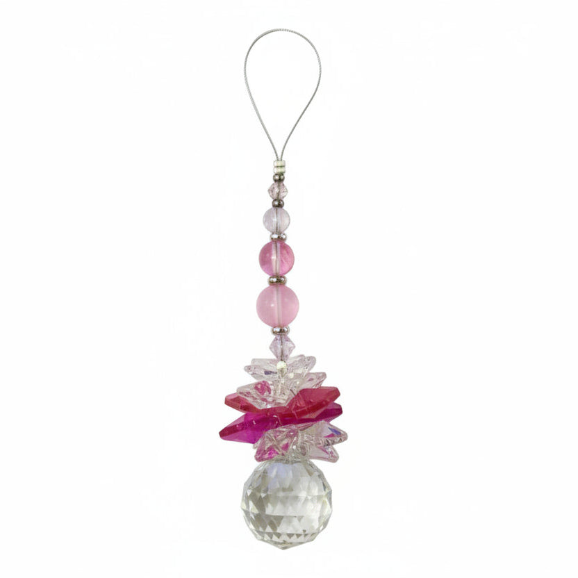 Decorative phone charm with pink butterfly and crystal on a white background