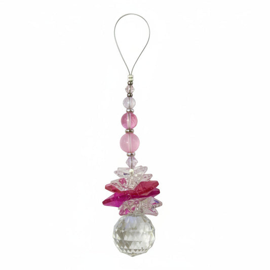 Decorative phone charm with pink butterfly and crystal on a white background