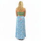 Person wearing a green strapless top and blue floral skirt in a store setting.