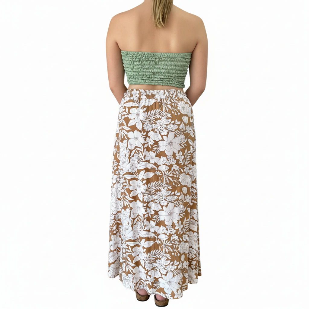 Person wearing a floral skirt in an indoor setting