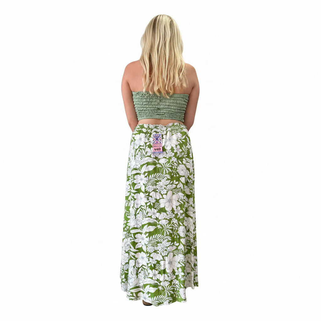 Person wearing a green floral skirt in a store setting
