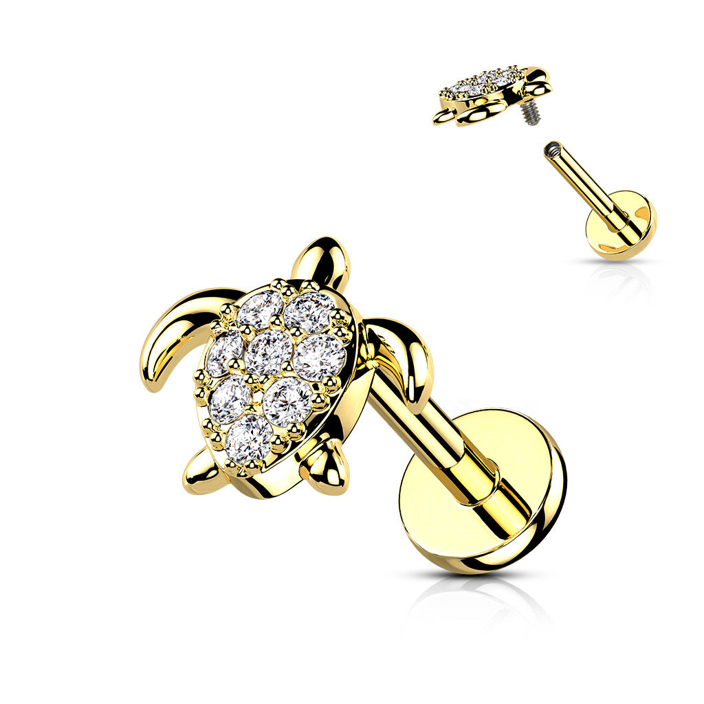 Gold turtle-shaped earring with clear gemstones on a white background