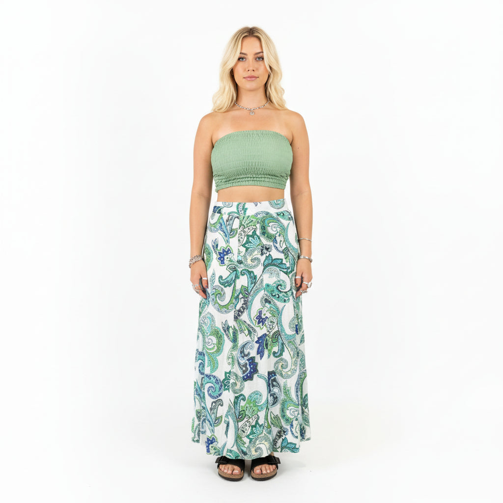 Person wearing a green top and patterned skirt in a store setting