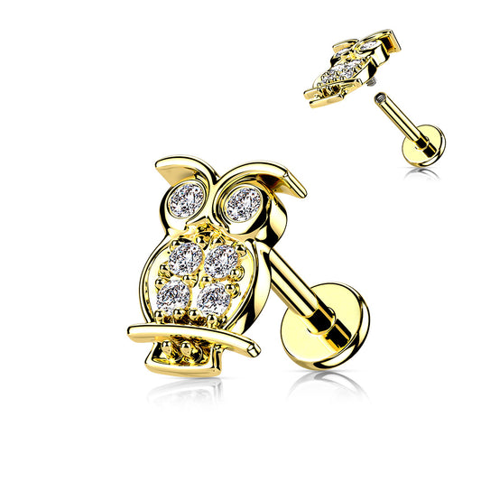 Gold owl-shaped earring with clear gemstones on a white background