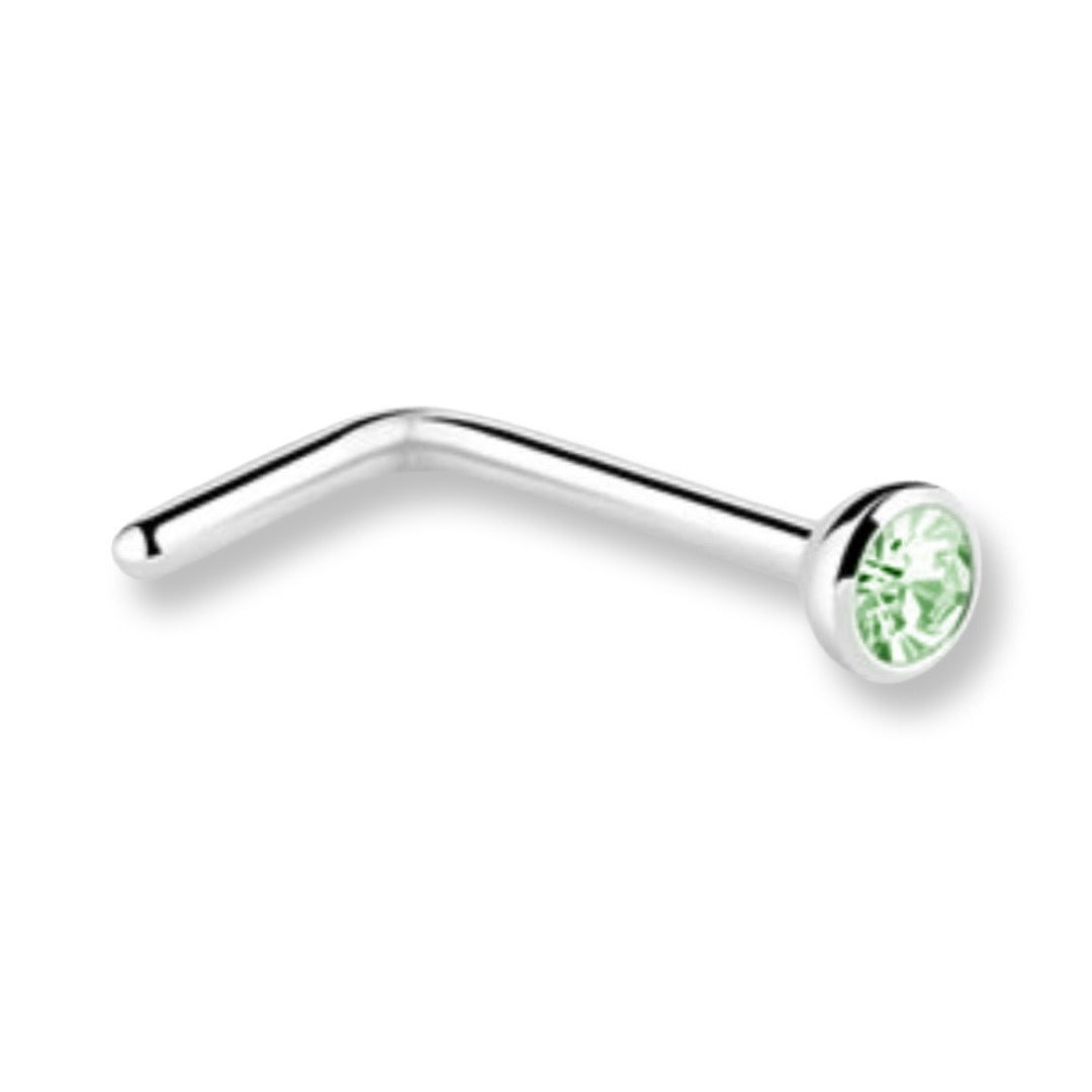 A curved silver-tone labret piercing stud with a round bezel-set light green gemstone, shown on a plain white background.