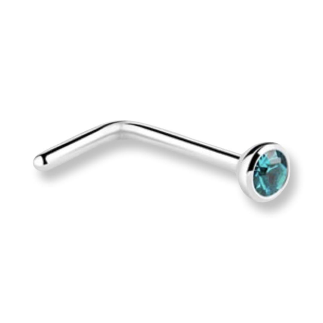 A silver-toned curved barbell nose stud with a faceted teal blue gemstone in a bezel setting, shown on a plain white background.