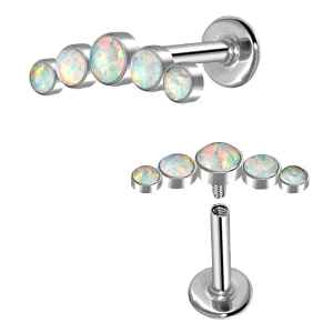 Pair of labret earrings with opal gemstones on a white background