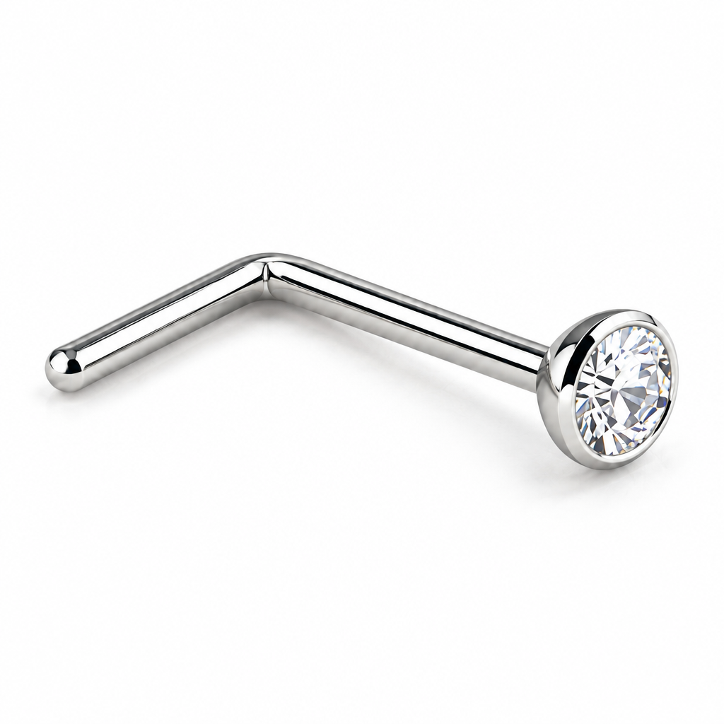 A silver-toned curved barbell stud piercing with a clear faceted gemstone in a bezel setting, shown on a plain white background.