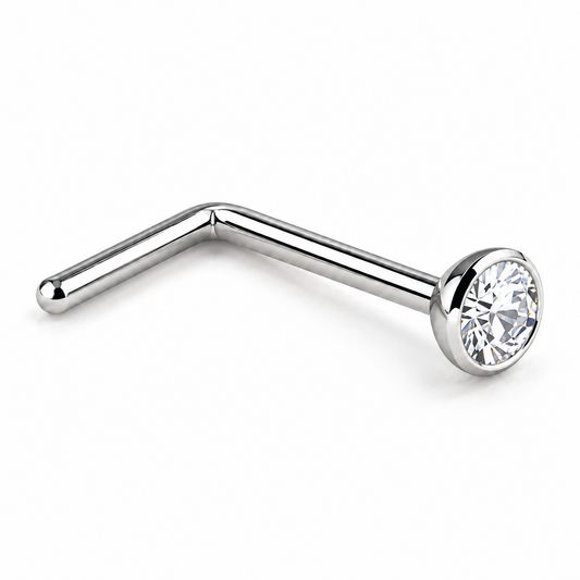 A silver-toned curved barbell stud piercing with a clear faceted gemstone in a bezel setting, shown on a plain white background.
