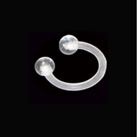A clear silicone or rubber ring with two spherical bead-like ends, shown on a solid black background.